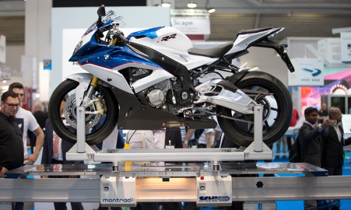 BMW is a SCHMID customer and has provided a motorcycle for the trade show appearance, symbolizing the characteristics of the transport system montrac®: To bring goods to their destination quickly and safely.Photo by SCHMID Group